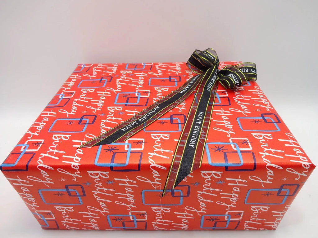 Close-up of Maybelline birthday beauty box with ribbon bow