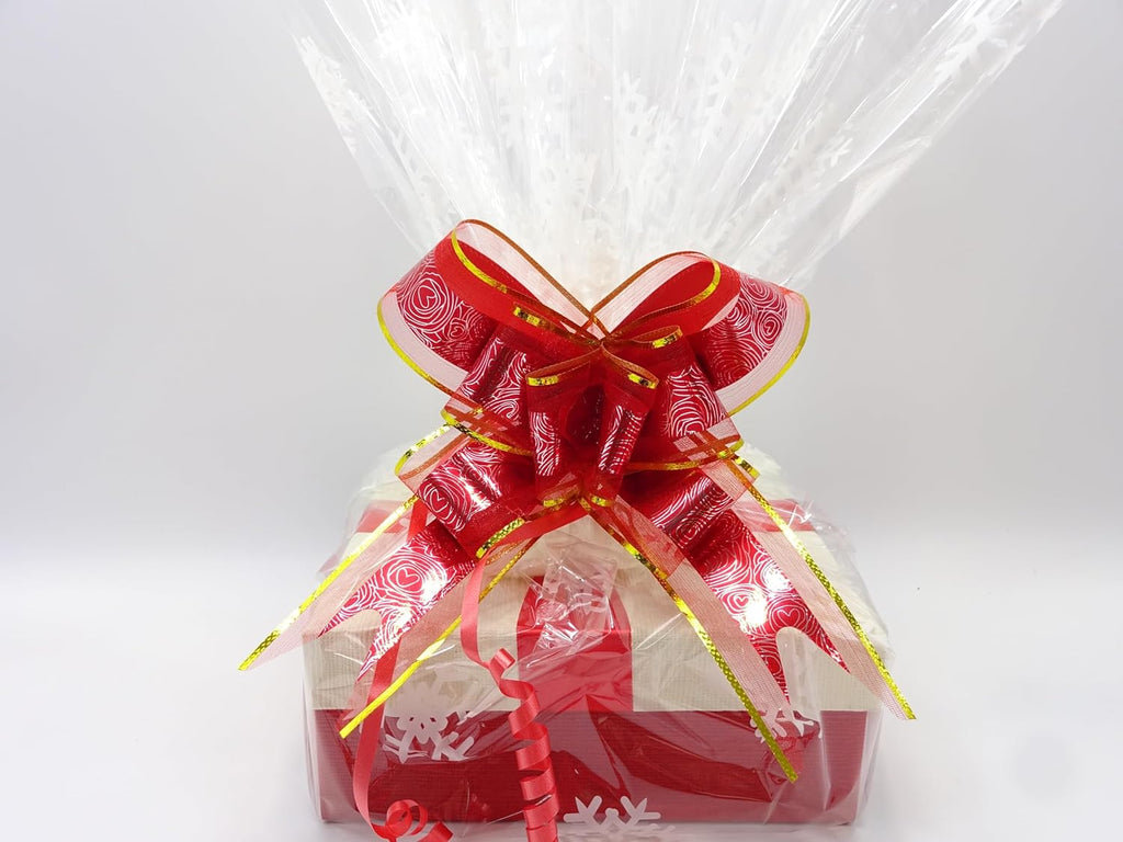 Fully wrapped Maybelline Christmas bundle with clear plastic wrap and red ribbon featuring snowflake designs