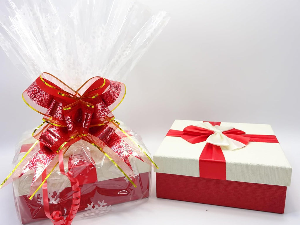 Close-up of the wrapped Maybelline Christmas gift box, featuring a festive red and gold bow