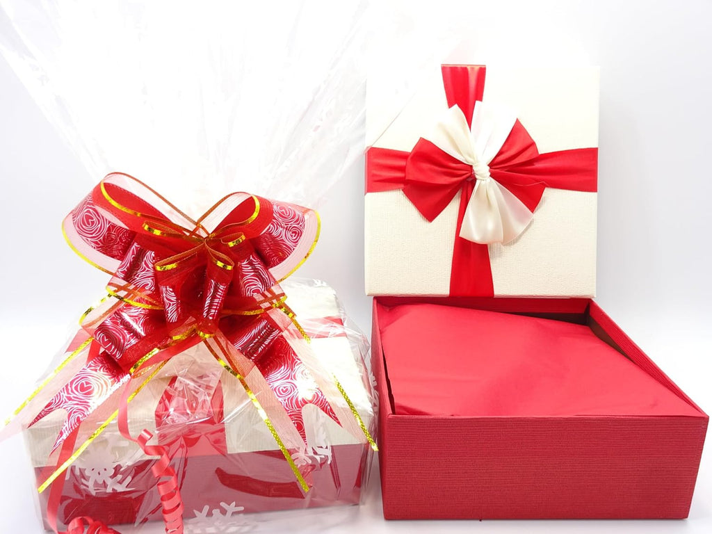 Opened Maybelline gift box with luxurious red and white bow, displayed alongside wrapped gift