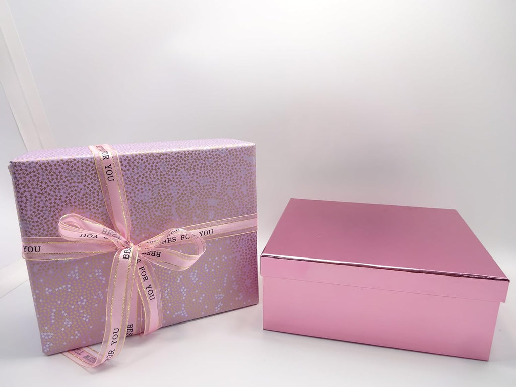 Pink and gold gift box sealed with a 'Best Wishes for You' ribbon