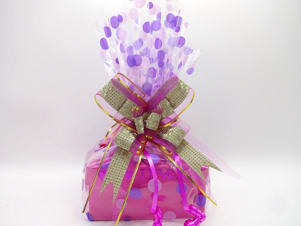 A close-up of the gift hamper wrapped in purple and gold with a statement bow, highlighting the luxurious gift wrap.