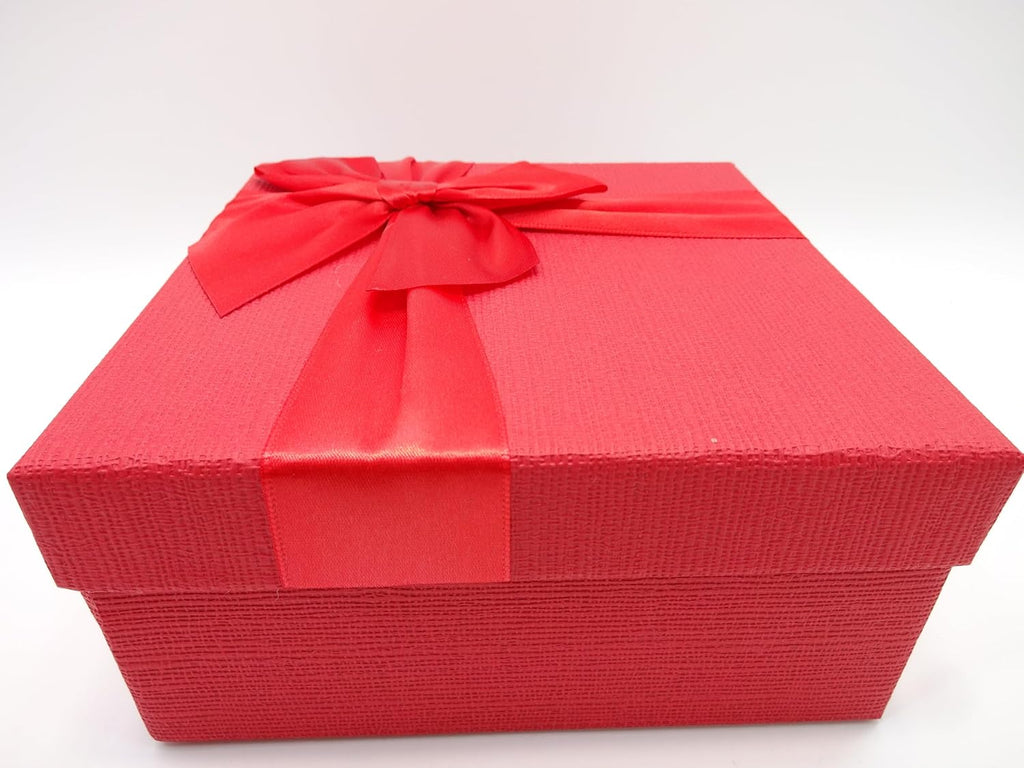 Sealed red gift box with a beautiful ribbon bow for a luxurious feel