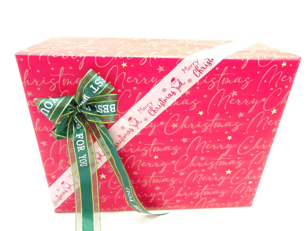 Close-up of red Merry Christmas themed wrapping with green and white bow