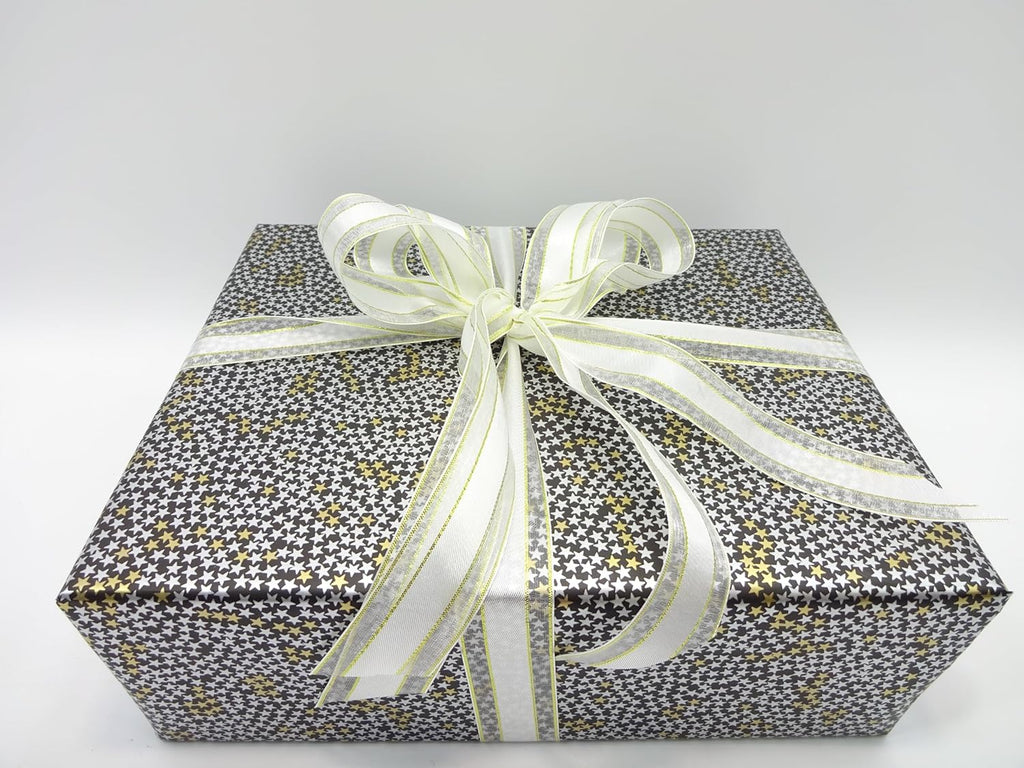 Father's Day 2025 men’s gift box with black, gold and white star print and white ribbon bow, top angle view
