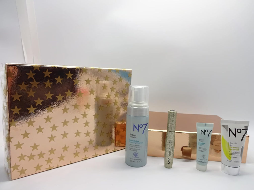 No7 Indulgence Skincare & Mascara Collection, beautifully wrapped in a luxurious gold-toned gift box with star patterns, topped with a matching gold ribbon.