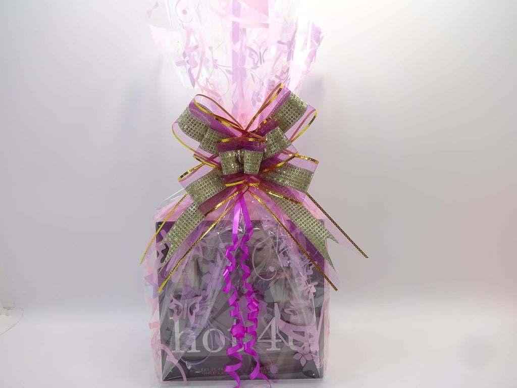 Beautifully wrapped Hot 4u perfume and makeup gift hamper with a pink bow, ready for gifting.