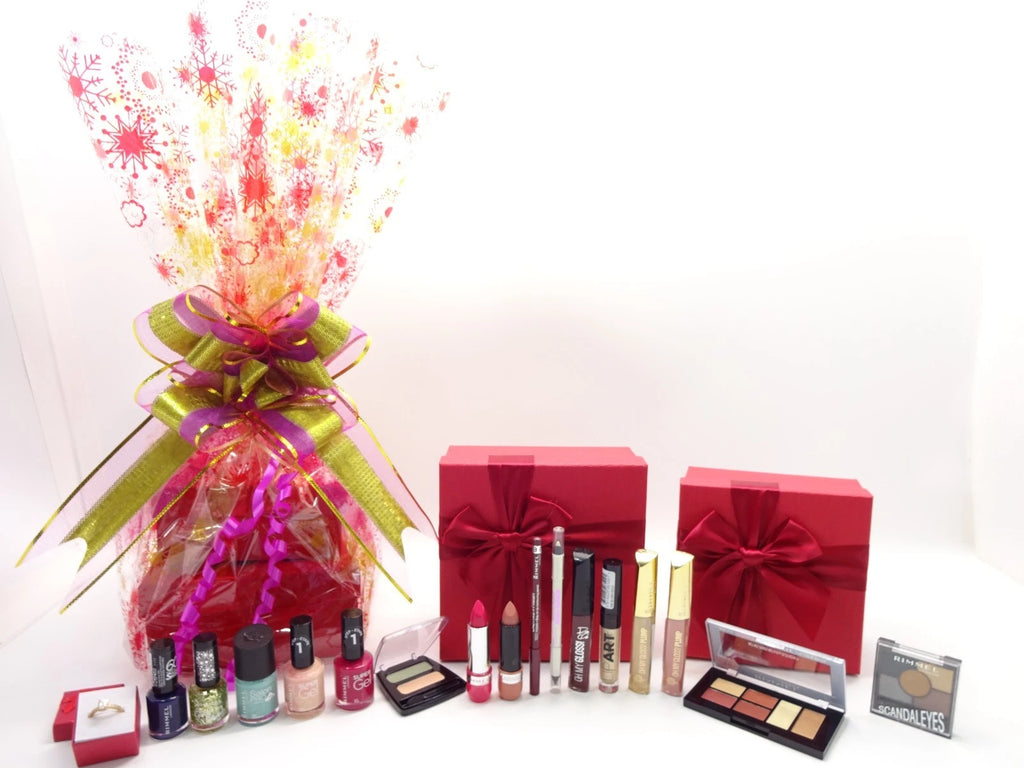 Unwrapped Rimmel London 16 piece beauty gift set displayed with makeup, nail polish, and palettes