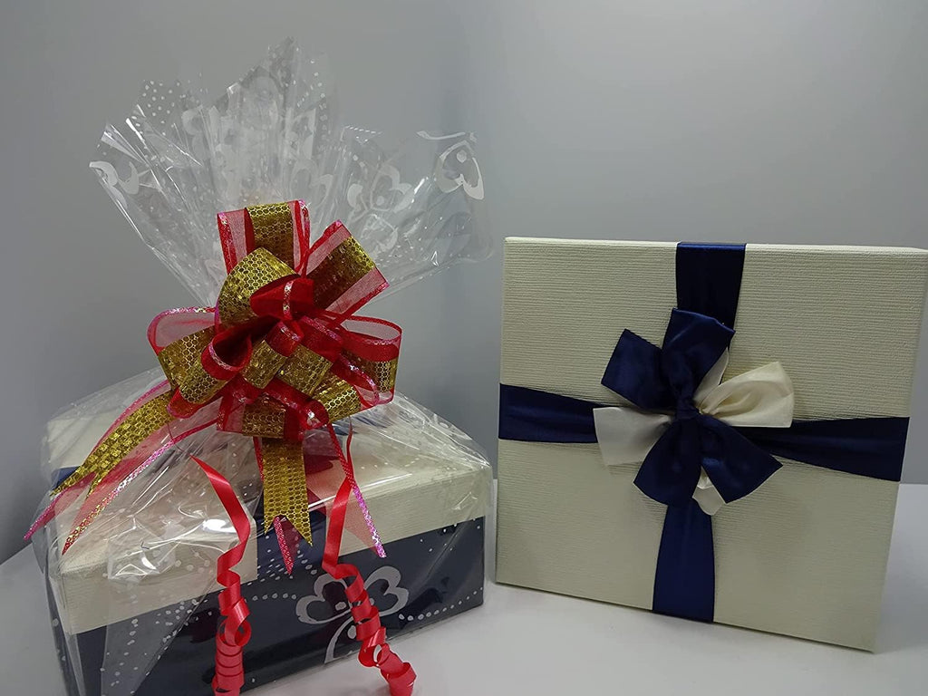 Gift box wrapped in a white ribbon with a deep blue bow, showing elegant packaging.