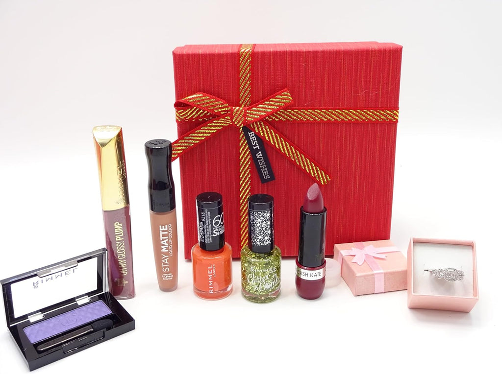 Contents of Rimmel London Gift Box, featuring various beauty products like lipsticks, nail polishes, and gloss, all placed neatly next to a small jewelry box with a ring.