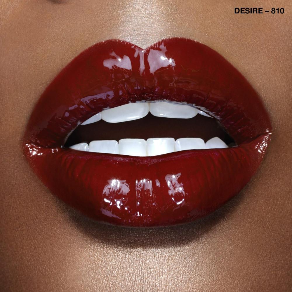 Close-up of lips wearing Rimmel Rita Ora 810 Desire, showing intense glossy burgundy color