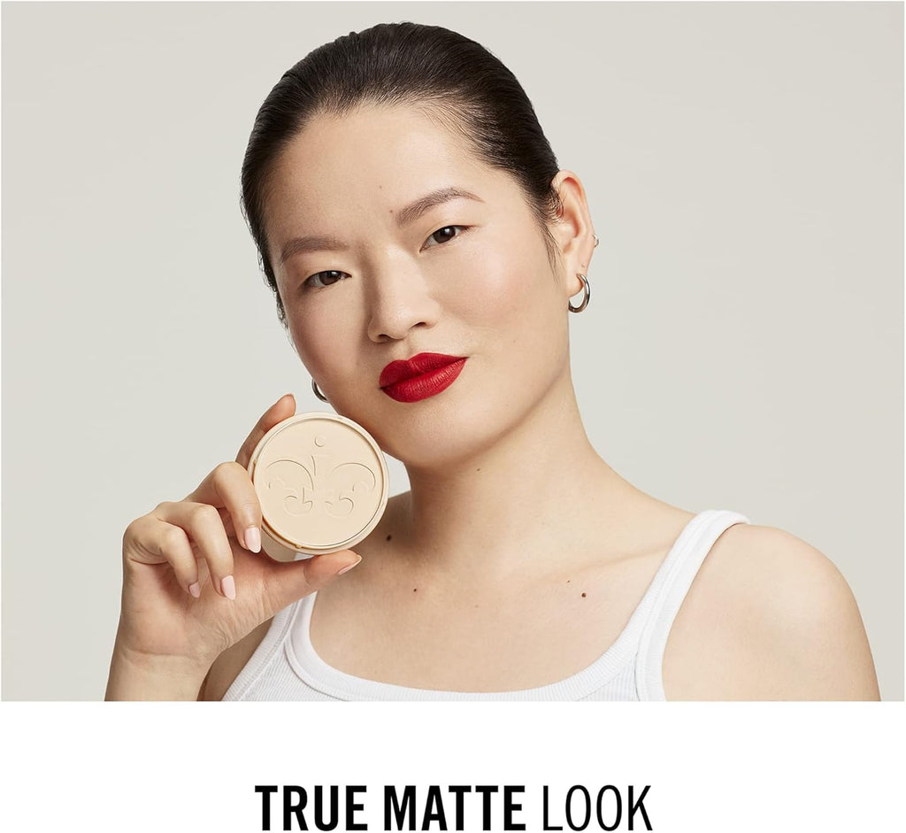 Model holding Rimmel Stay Matte Powder 002 Pink Blossom compact for flawless matte look