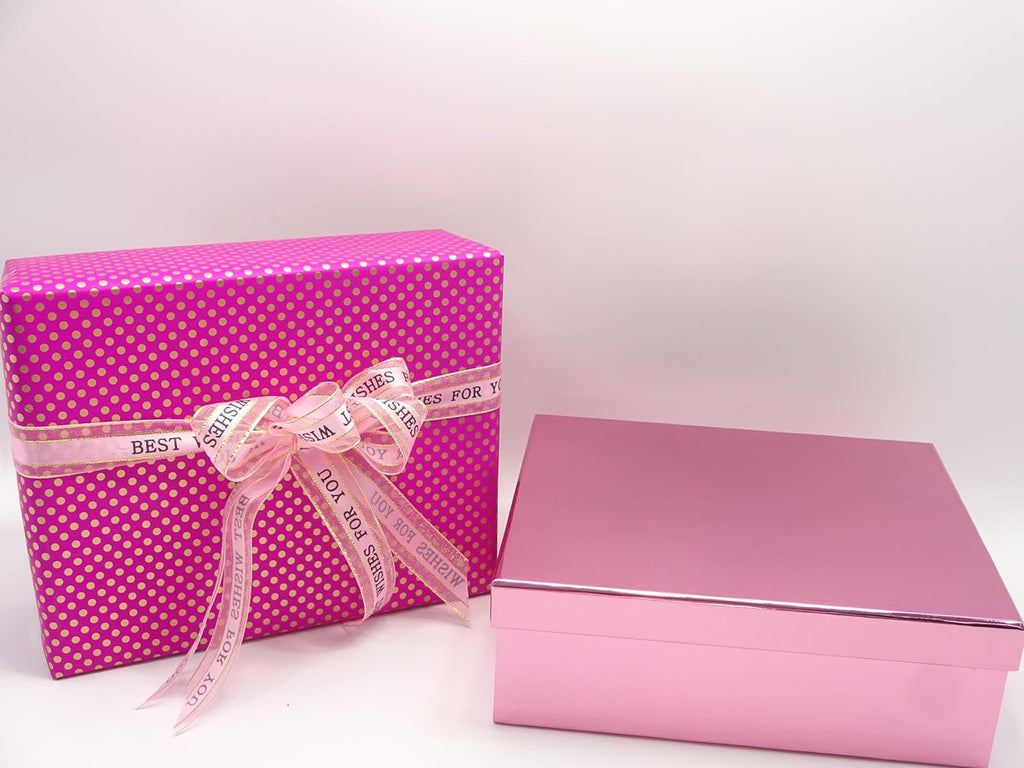 Pink makeup gift box and brush set wrapped in premium gold-dotted pink paper with a ribbon