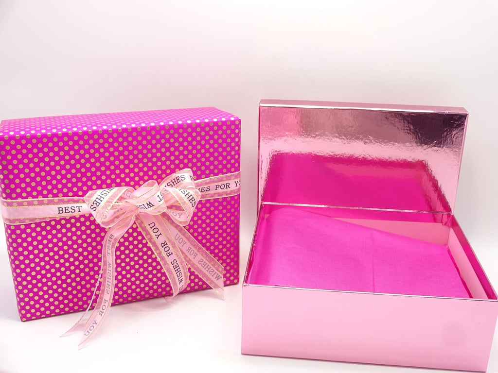 Open pink gift box revealing tissue-wrapped luxury makeup items and brushes inside