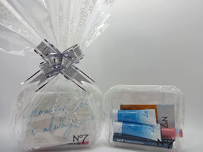 No7 beauty bundle gift hamper with snowflake design wrapping and silver ribbon from a side angle.