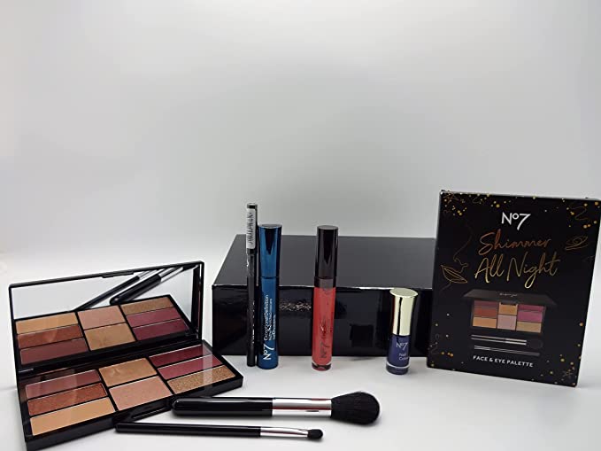 Display of No7 beauty bundle contents including face and eye palette, makeup brushes, mascara, and lip glaze.