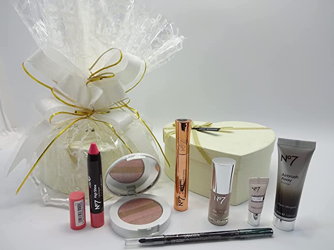 Close-up of No7 makeup products, including the High Shine Lip Crayon, Gel Finish Nail Polish, and Airbrush Away Primer, all placed beside the beautifully wrapped hamper.